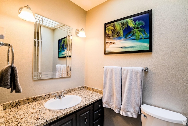 bathroom featuring toilet and vanity