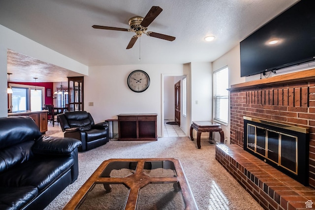 living room featuring light carpet, plenty of natural light, a textured ceiling, and a brick fireplace