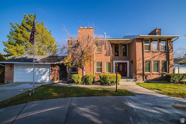 view of front of house featuring a garage and a front yard