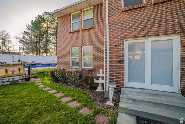 rear view of house featuring a yard