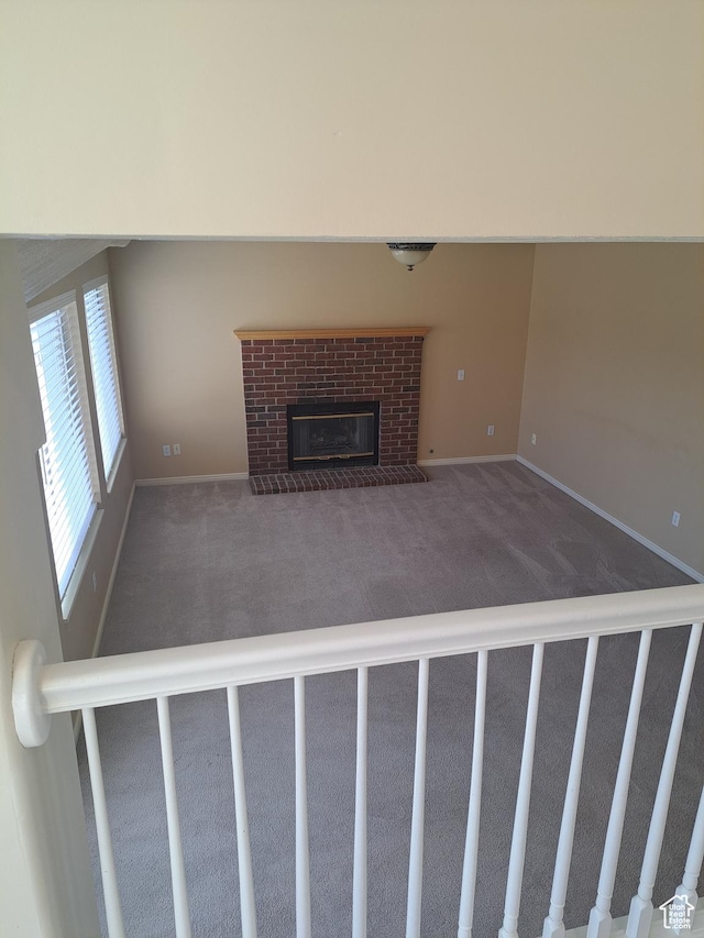 913 S 1320 E, Pleasant Grove, UT 84062 - unfurnished living room with a brick fireplace and dark colored carpet