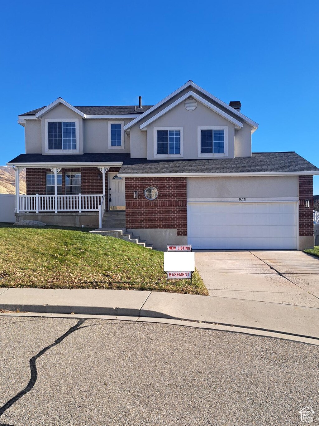 913 S 1320 E, Pleasant Grove, UT 84062 - traditional-style home featuring brick siding, driveway, stucco siding, and covered porch