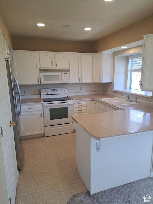 913 S 1320 E, Pleasant Grove, UT 84062 - kitchen with white cabinetry, sink, white appliances, and kitchen peninsula