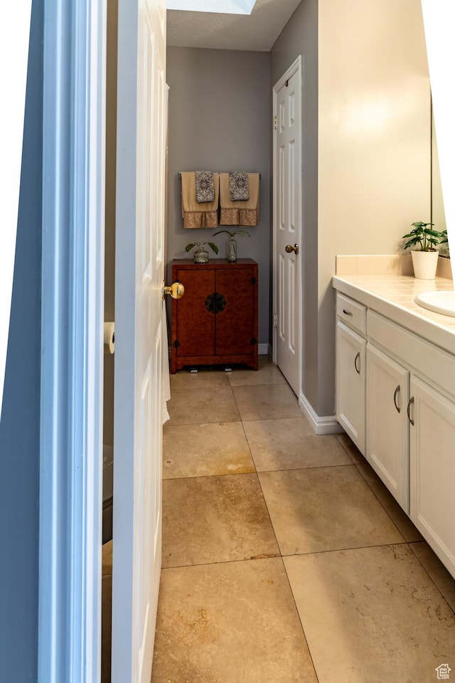 1158 E 650 N, Ogden, UT 84404 - bathroom featuring vanity, a skylight, and baseboards