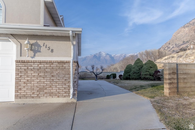 1158 E 650 N, Ogden, UT 84404 - view of home's exterior with a mountain view, stucco siding, and brick siding