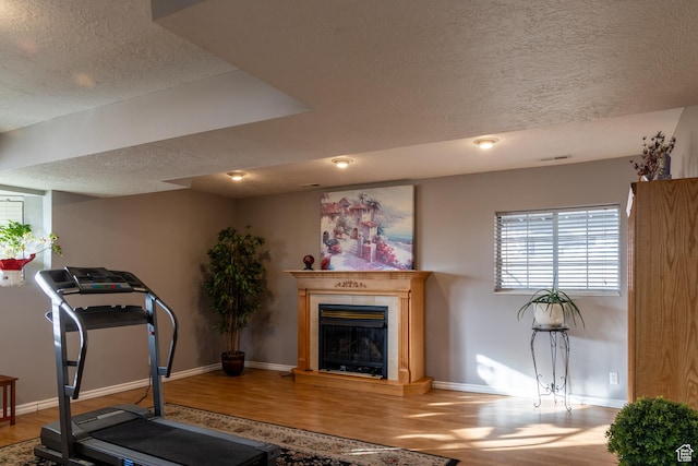 1158 E 650 N, Ogden, UT 84404 - exercise room featuring a textured ceiling, wood finished floors, baseboards, and a glass covered fireplace