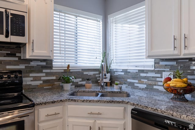 1158 E 650 N, Ogden, UT 84404 - kitchen featuring stainless steel appliances, a sink, white cabinets, and tasteful backsplash