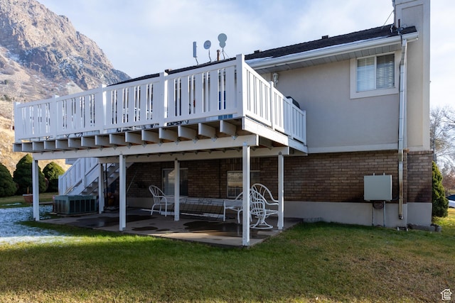 1158 E 650 N, Ogden, UT 84404 - rear view of property featuring a patio area, a lawn, central AC, and a deck with mountain view