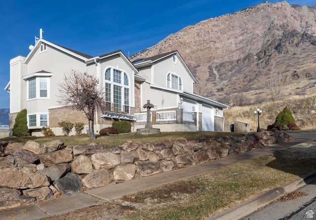 1158 E 650 N, Ogden, UT 84404 - view of front of house featuring a mountain view, stucco siding, and a garage