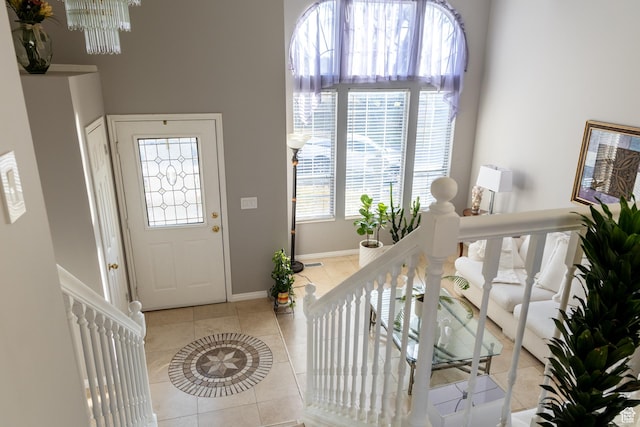 1158 E 650 N, Ogden, UT 84404 - entrance foyer with light tile patterned floors, baseboards, a chandelier, and stairway