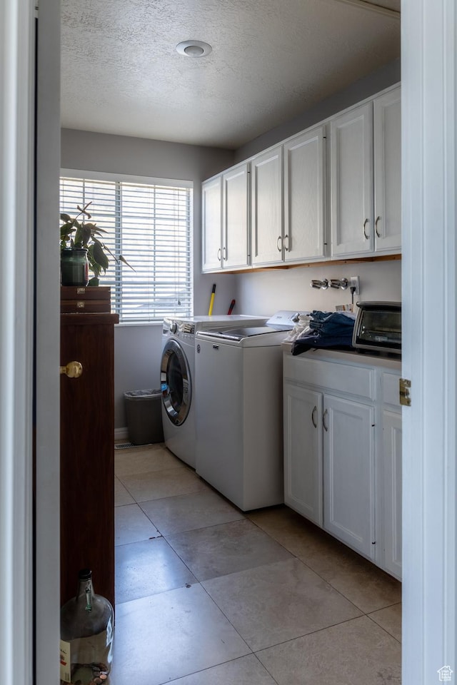 1158 E 650 N, Ogden, UT 84404 - laundry area with cabinet space, independent washer and dryer, a textured ceiling, and light tile patterned floors