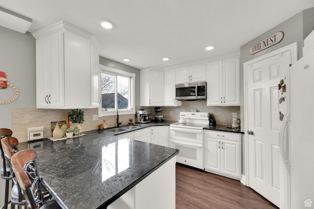 538 E 1200 S, Kaysville, UT 84037 - kitchen with white appliances, dark wood-type flooring, sink, kitchen peninsula, and white cabinetry