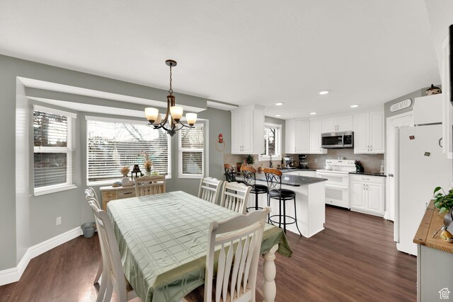 538 E 1200 S, Kaysville, UT 84037 - dining space featuring a chandelier, a wealth of natural light, and dark wood-type flooring