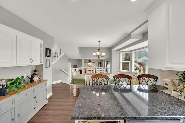 538 E 1200 S, Kaysville, UT 84037 - kitchen with a chandelier, pendant lighting, dark hardwood / wood-style flooring, and white cabinetry