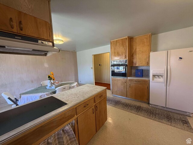 885 N 600 E, Price, UT 84501 - kitchen with white refrigerator with ice dispenser, oven, brown cabinets, light countertops, and light flooring