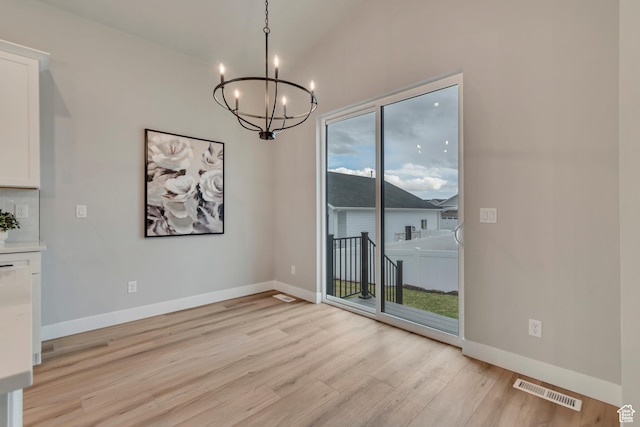 3527 W Haven Aire, South Jordan, UT 84095 - unfurnished dining area with lofted ceiling, a chandelier, visible vents, baseboards, and light wood finished floors