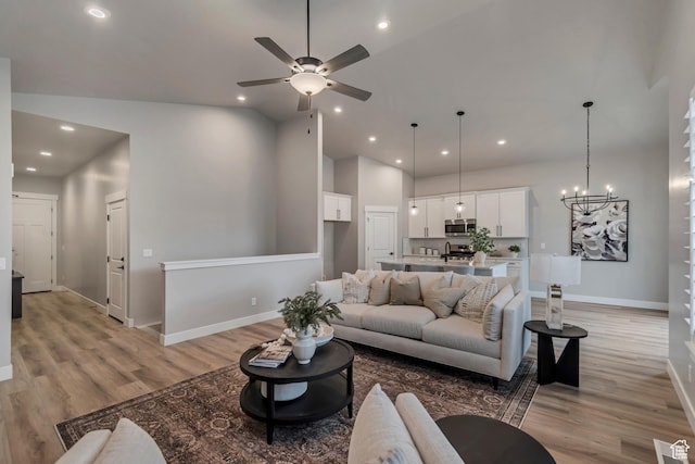 3527 W Haven Aire, South Jordan, UT 84095 - living area with high vaulted ceiling, baseboards, light wood-style flooring, and ceiling fan with notable chandelier