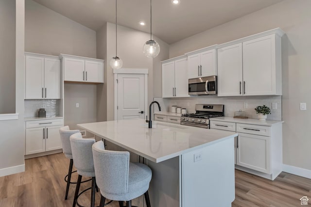 3527 W Haven Aire, South Jordan, UT 84095 - kitchen with a sink, decorative backsplash, a center island with sink, white cabinetry, and appliances with stainless steel finishes