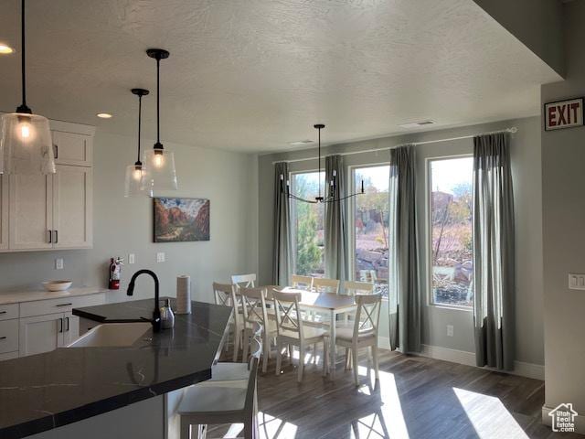 3260 Retreat Dr S, Hurricane, UT 84737 - dining room featuring a textured ceiling, sink, and dark wood-type flooring