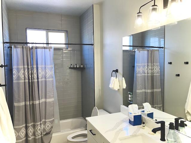 3260 Retreat Dr S, Hurricane, UT 84737 - full bathroom featuring vanity, shower / bathtub combination with curtain, and toilet