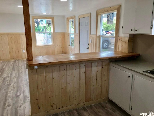 250 W 700 S, Richfield, UT 84701 - kitchen featuring white cabinets, wooden walls, dark wood-type flooring, and plenty of natural light