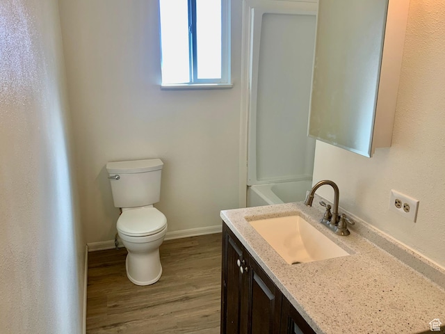 250 W 700 S, Richfield, UT 84701 - bathroom featuring wood-type flooring, toilet, and vanity
