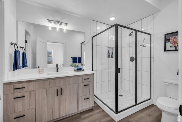 1218 Sawmill Blvd Unit 104, Heber City, UT 84032 - bathroom with walk in shower, wood-type flooring, a textured ceiling, toilet, and vanity