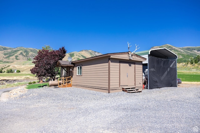 exterior space featuring a mountain view and a storage unit