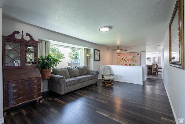 living room with dark hardwood / wood-style floors and a textured ceiling