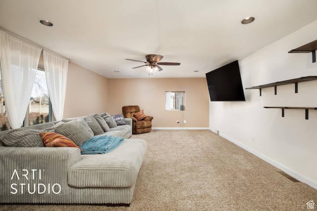 living room featuring carpet floors, plenty of natural light, and ceiling fan