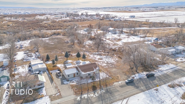 snowy aerial view featuring a mountain view