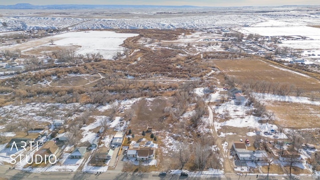 snowy aerial view featuring a mountain view