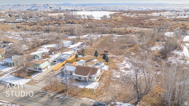 snowy aerial view featuring a mountain view