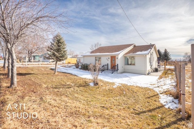 ranch-style home with a front lawn and central AC