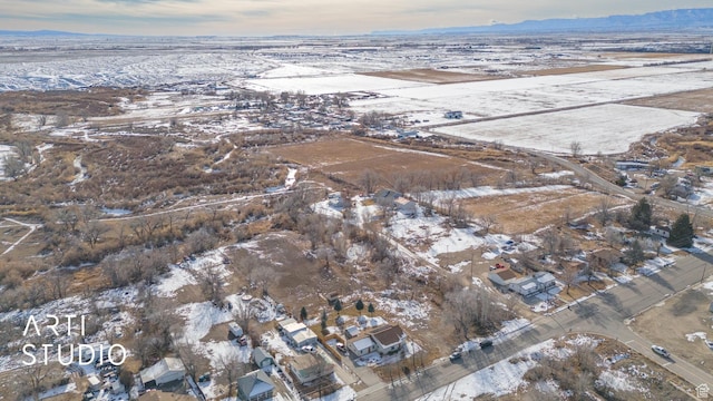 snowy aerial view featuring a mountain view