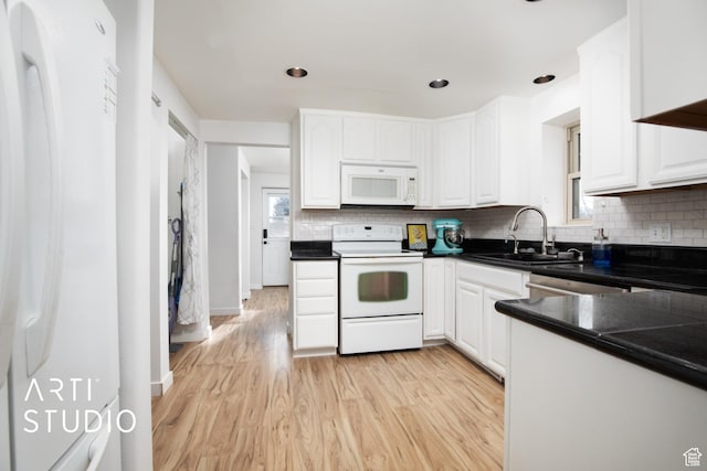 kitchen with white cabinetry, sink, white appliances, and light wood-type flooring
