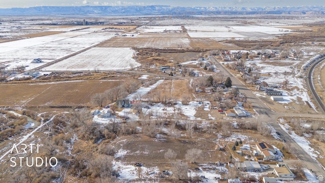 snowy aerial view featuring a mountain view