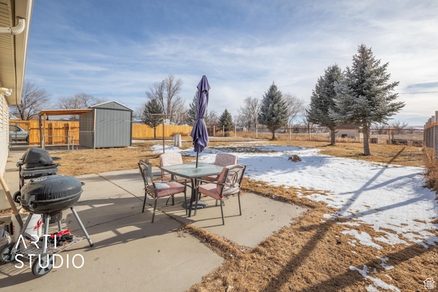 view of patio / terrace featuring a grill and a storage shed