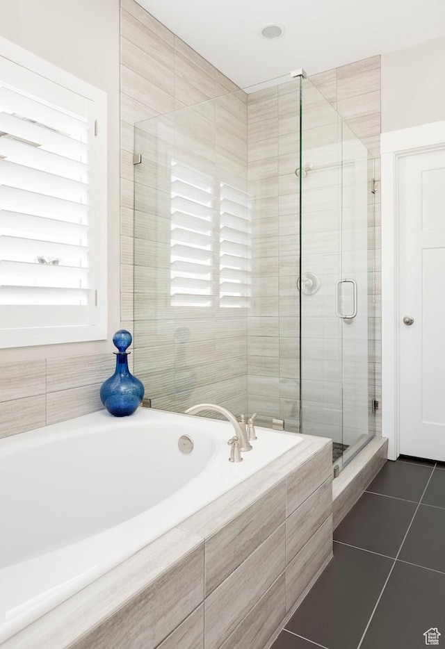 bathroom featuring plus walk in shower and tile patterned flooring
