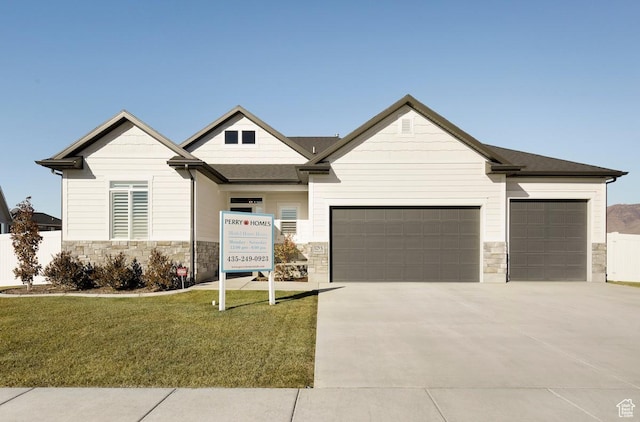 view of front of property featuring a front yard and a garage