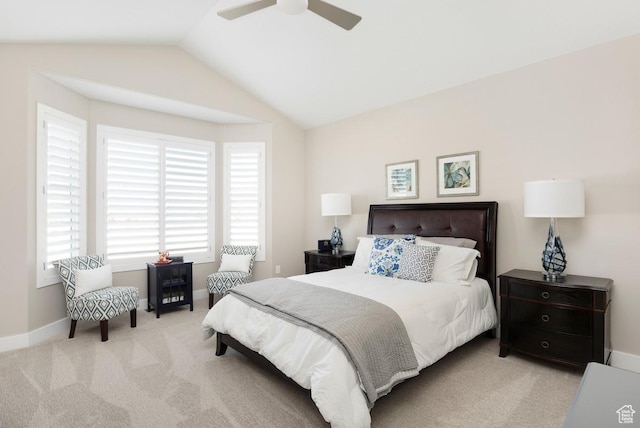 bedroom with ceiling fan, light carpet, and vaulted ceiling