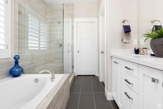 bathroom featuring tile patterned flooring, vanity, and shower with separate bathtub