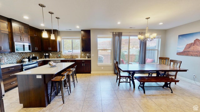 668 W 0470 N, Moab, UT 84532 - kitchen featuring appliances with stainless steel finishes, a breakfast bar, a notable chandelier, a center island, and hanging light fixtures