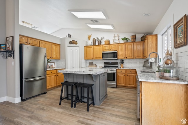 2461 W 1050 N, Hurricane, UT 84737 - kitchen featuring a center island, lofted ceiling, sink, and appliances with stainless steel finishes