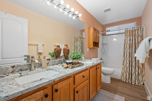 2461 W 1050 N, Hurricane, UT 84737 - full bathroom featuring hardwood / wood-style floors, shower / bath combination with curtain, toilet, and vanity
