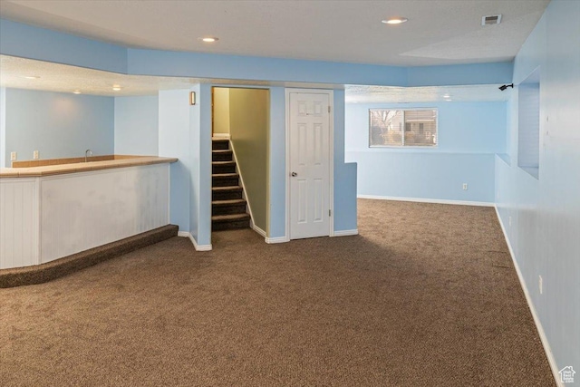 basement with bar area and carpet floors
