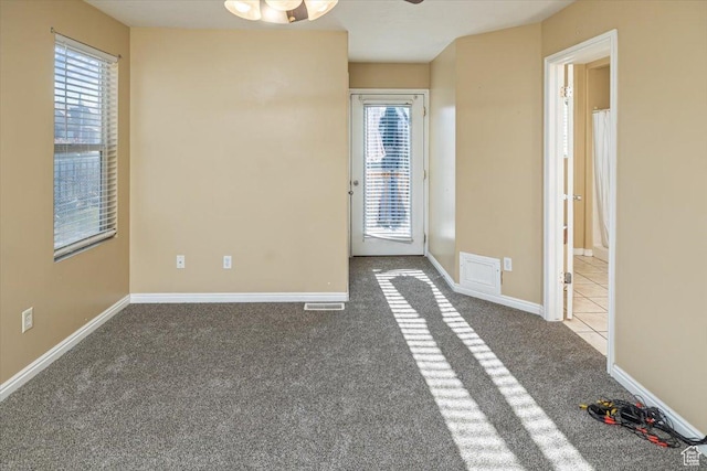 carpeted empty room with ceiling fan