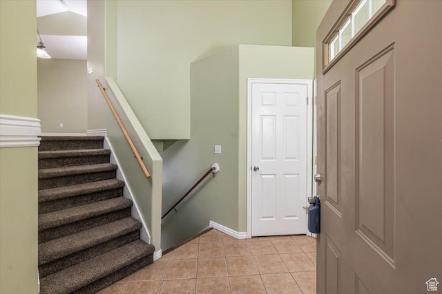 stairway with tile patterned floors