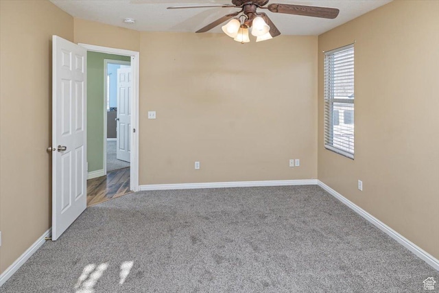 empty room with ceiling fan and carpet floors