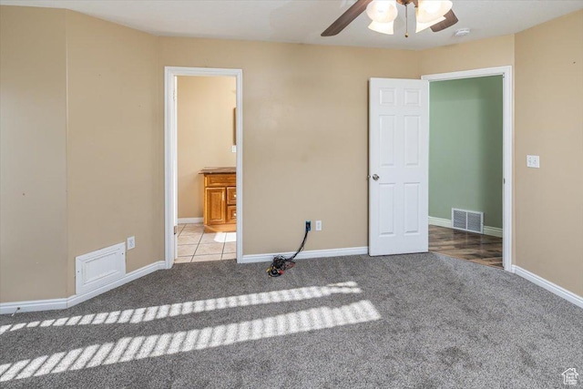 unfurnished bedroom with ceiling fan and light colored carpet